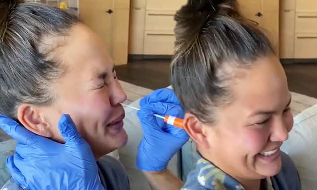 ‘It tickles!’ Chrissy Teigen squeals and giggles as she will be able to get her nose swabbed all over COVID-19 take a look at