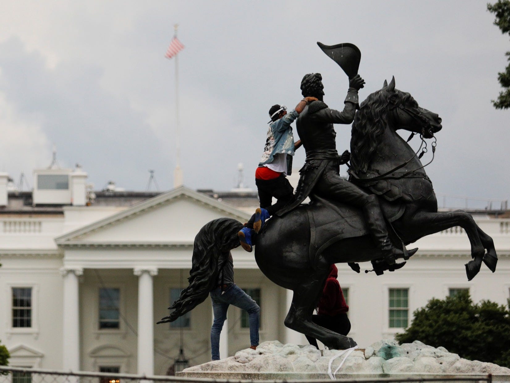 Four males were charged for attempting to glide down a statue of President Andrew Jackson advance the White House