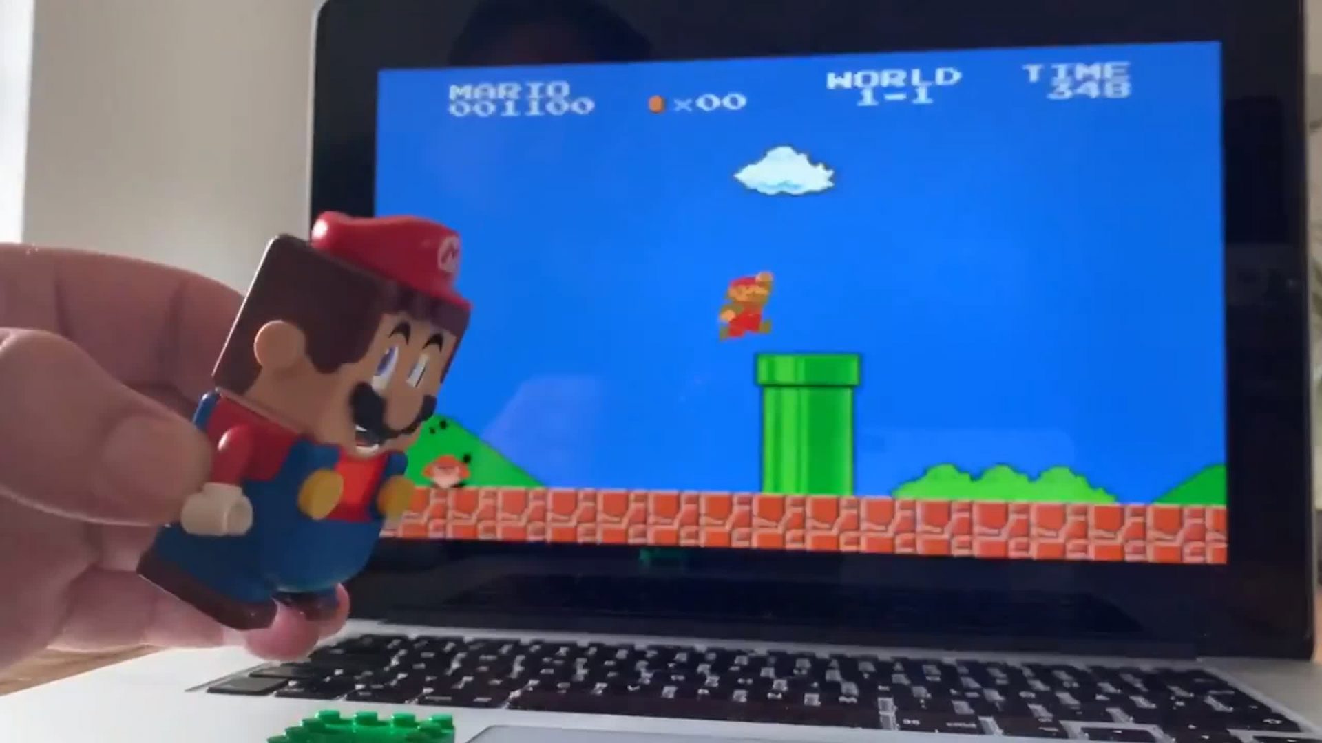 See Lego Mario controlling digital Mario