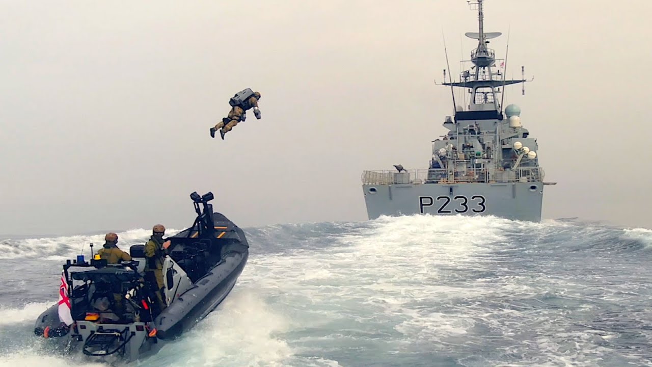 Royal Marines board a ship utilizing a jet pack