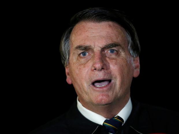 Brazil’s Bolsonaro fined as he flouts hide rule before motorcyclists
