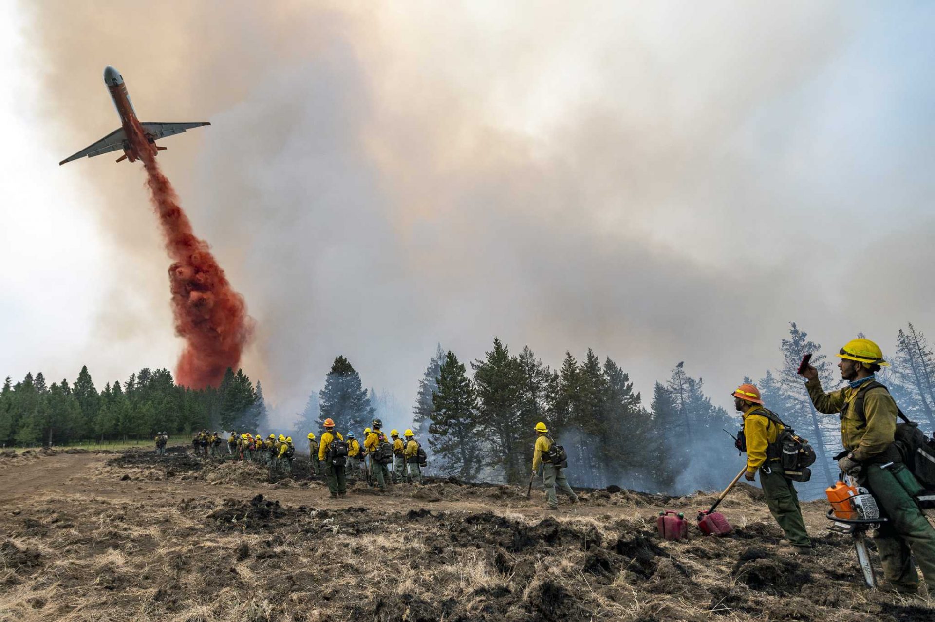 Hundreds of firefighters fight immense blazes right thru the West