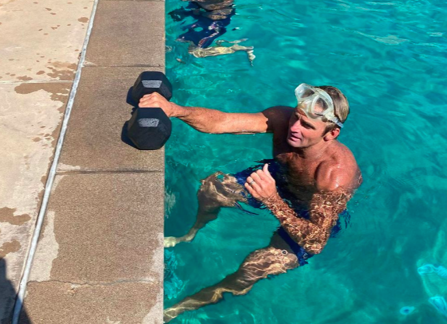 Gape Surfing Record Laird Hamilton Swim Laps Whereas Carrying a Dumbbell
